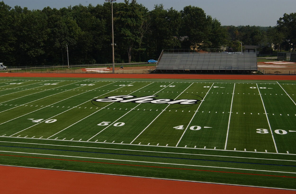 Athletic field with surrounding track and bleachers