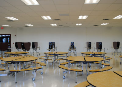 Interior of a school cafeteria with tables seating