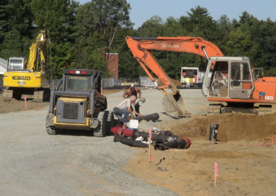 Crew digging ground to install fire hydrant system
