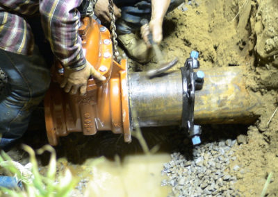 Assembling a water main tap underground